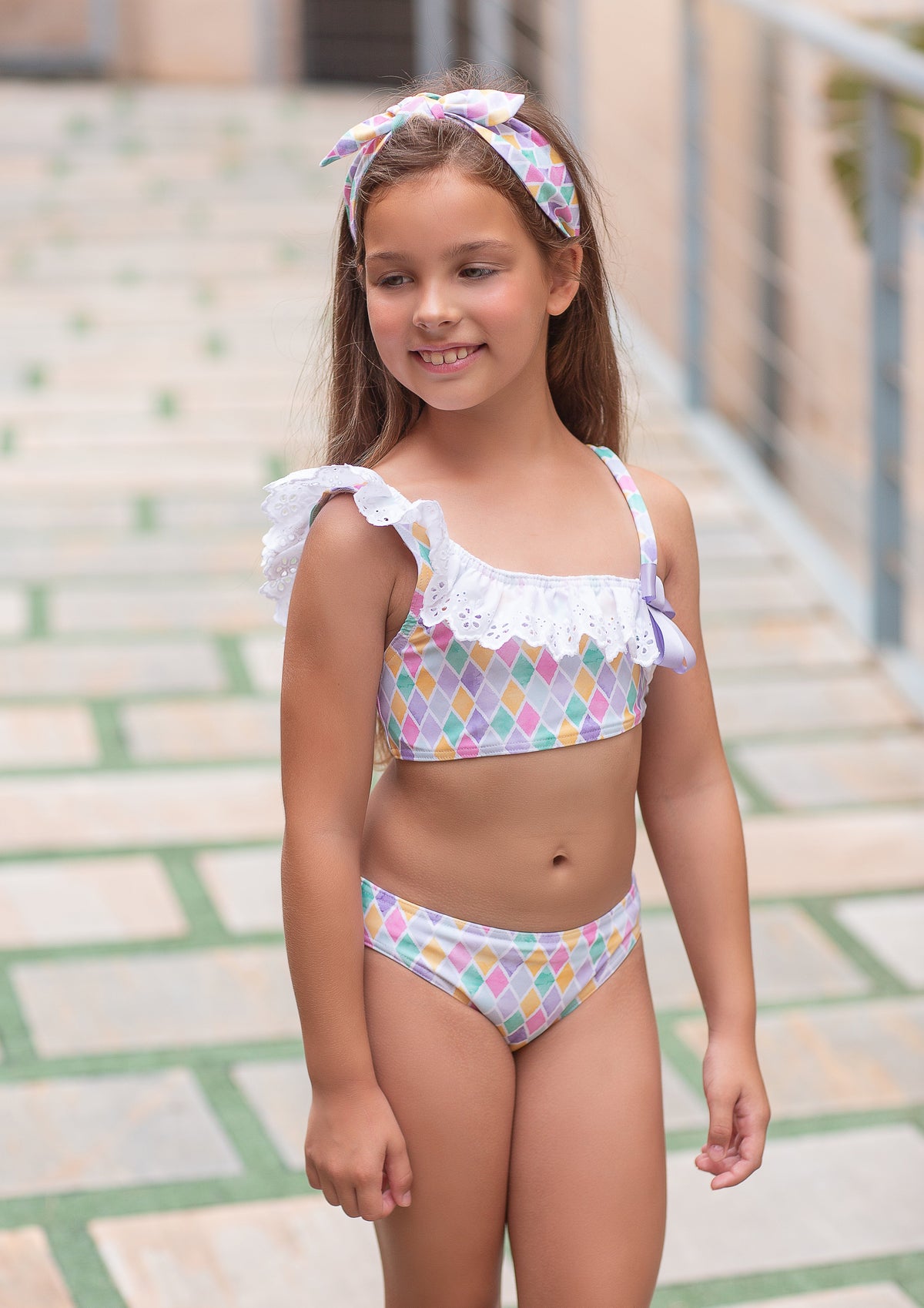 Rochy Diamonds girls lilac pastel two-piece bikini with white broderie anglaise frills and pink, mint and yellow diamond print