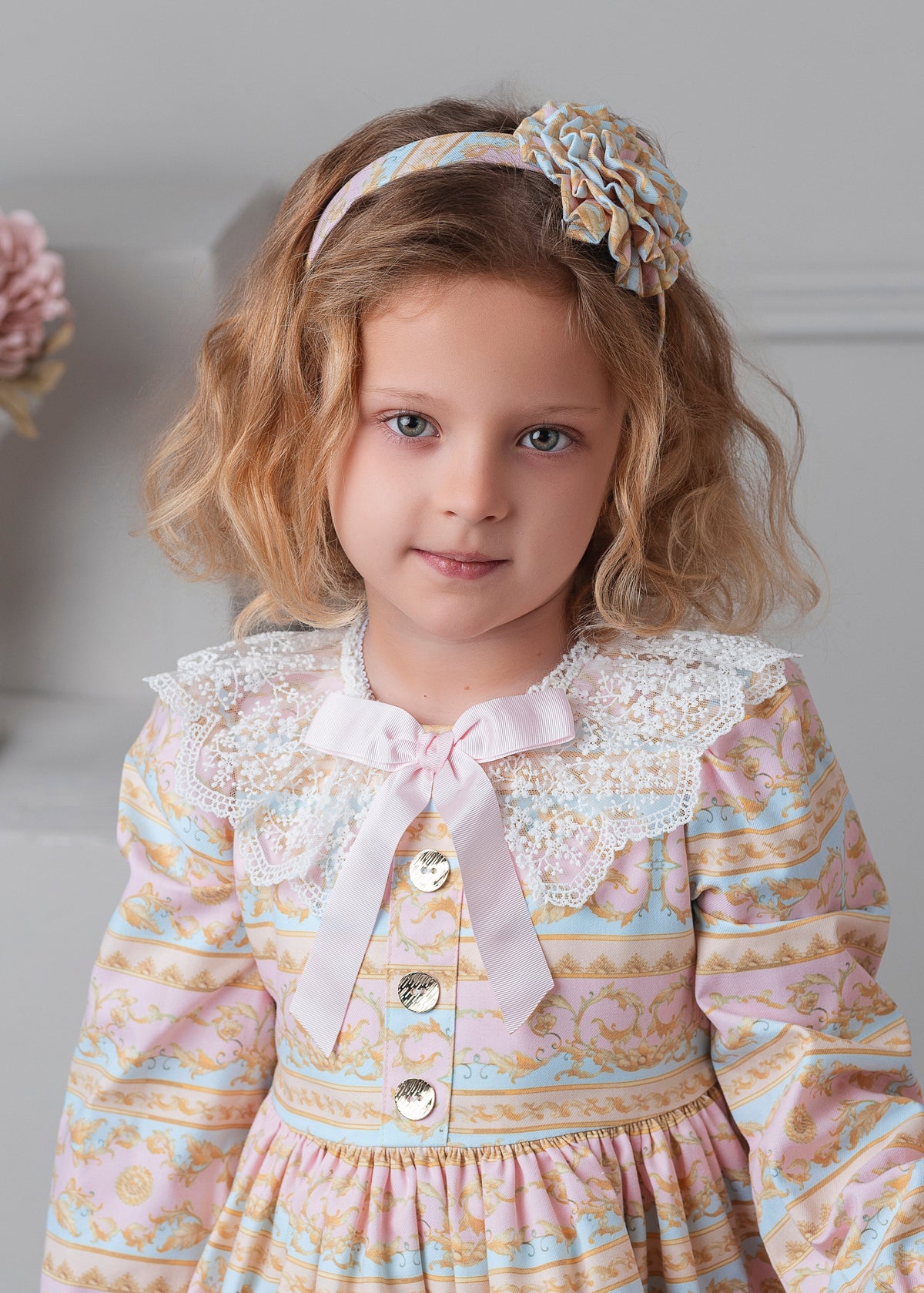 Rochy Rococo girls pink and pale blue patterned dress with cream lace collar, pink bow and metal buttons And matching headband
