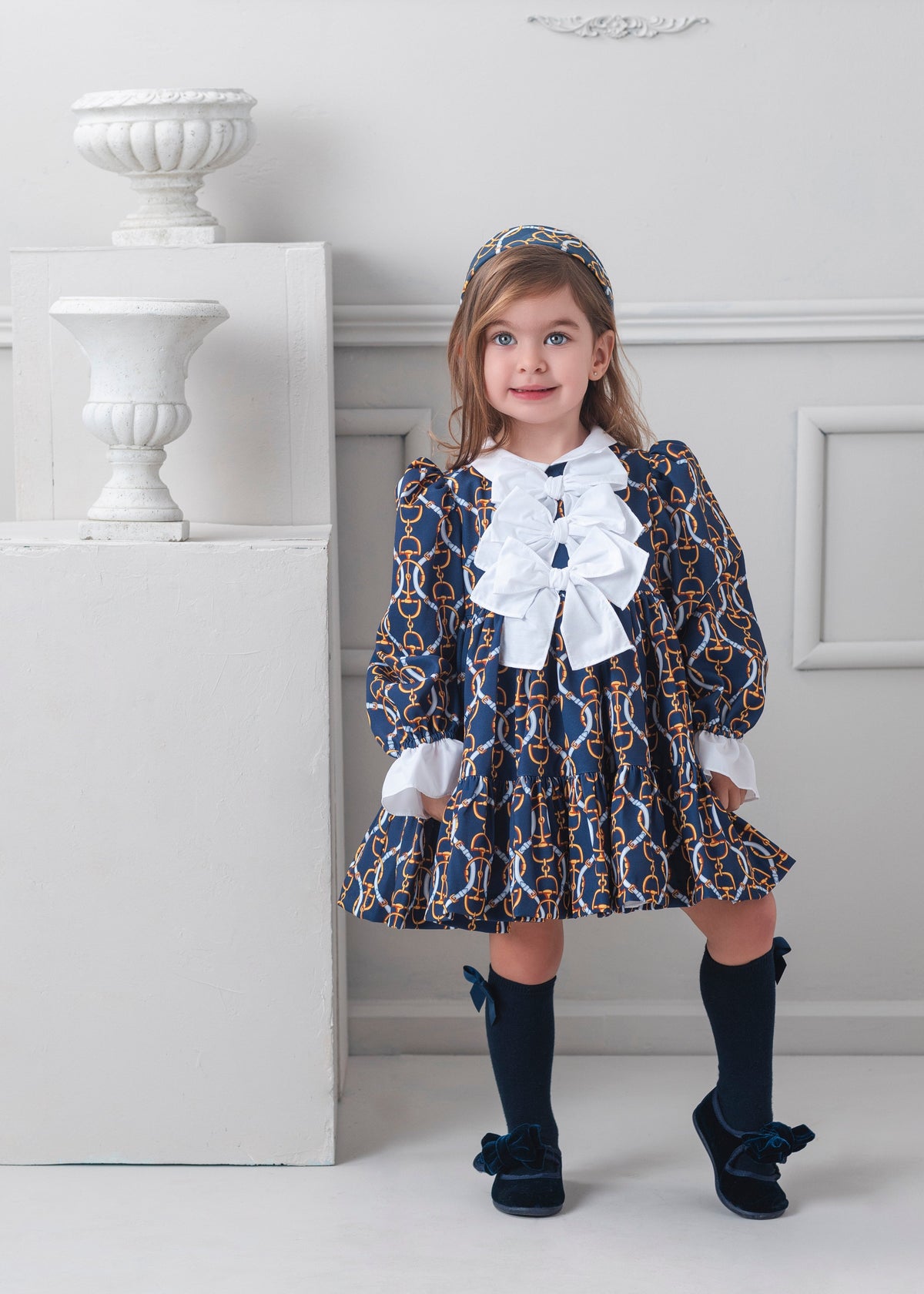 Rochy Vintage girls navy chain print dress with white collar, statement bows and frilled cuffs
