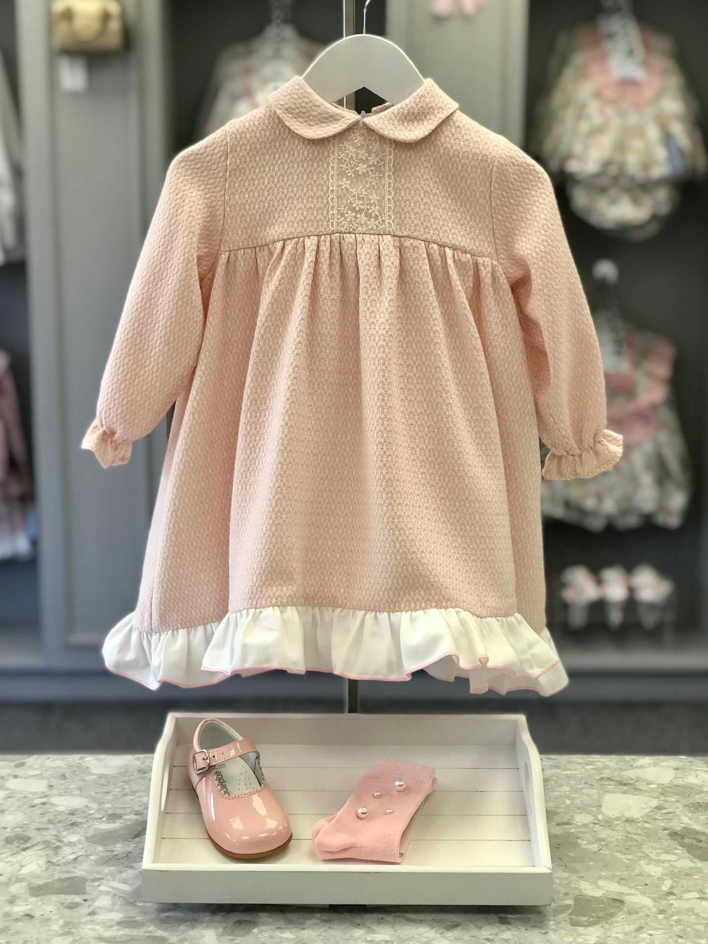 LOR Miral Elisa girls blush pink textured jacquard dress with Peter Pan collar, embroidered ivory lace front and contrasting cream frill hem