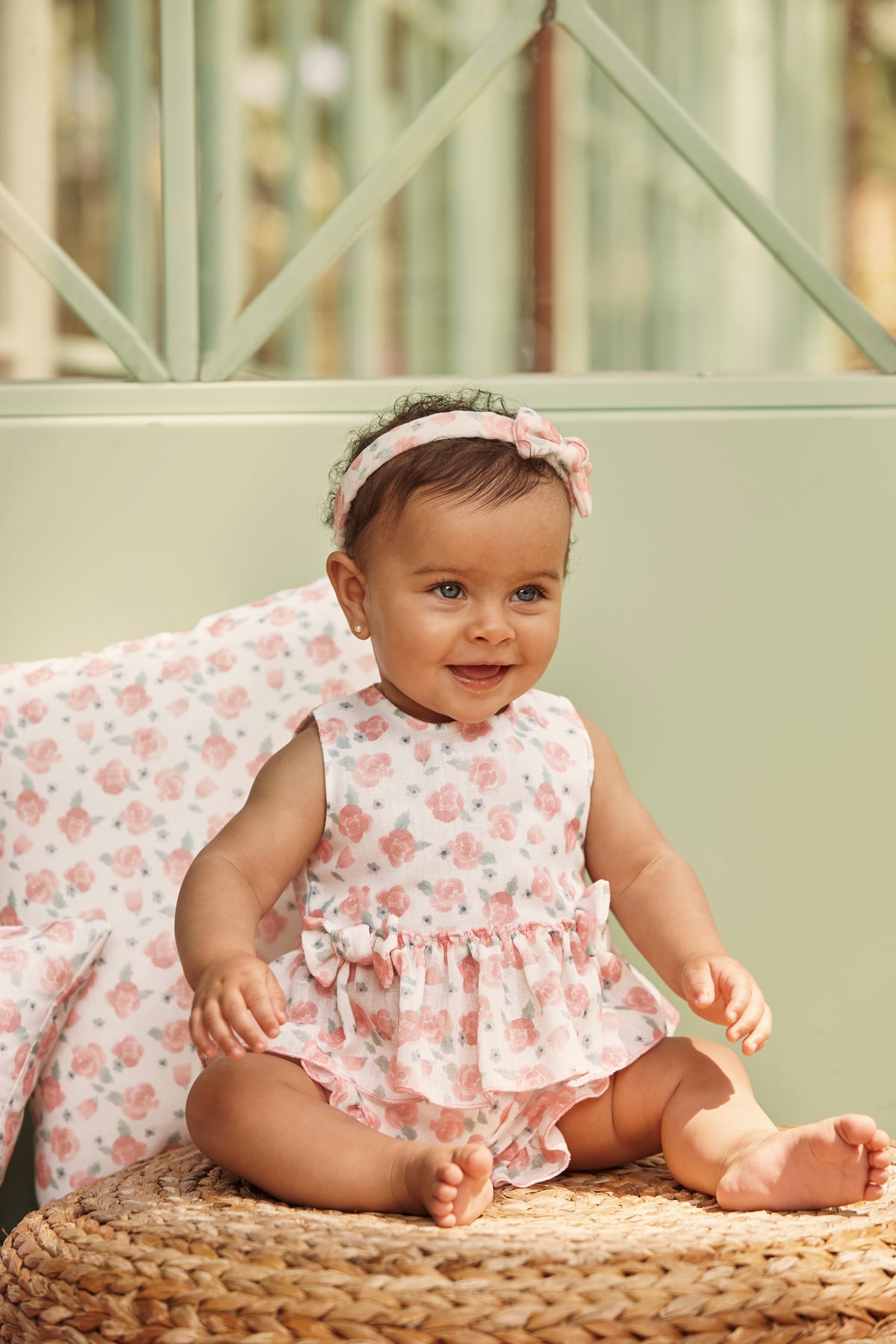 Baby girl wearing the Juliana Arandano peach floral top and matching ruffle shorts