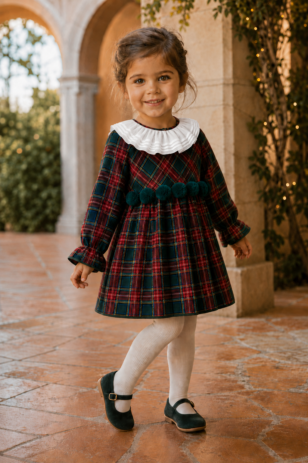Calamaro Galerna tartan dress with white cotton collar and green pom-poms, three-quarter view