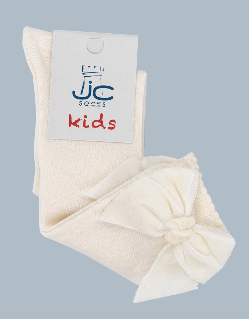 cream knee-high socks for girls with velvet bow detail by JC Castella