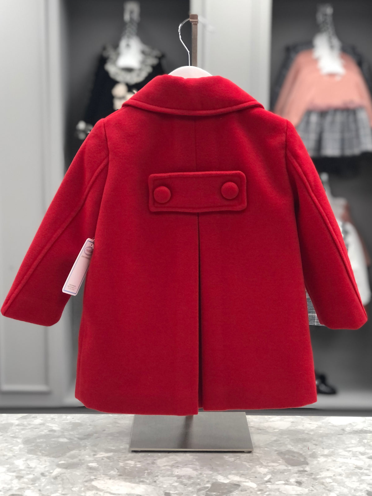 Eva Class Valeria girls red traditional coat back view with decorative two-button tab and central inverted pleat