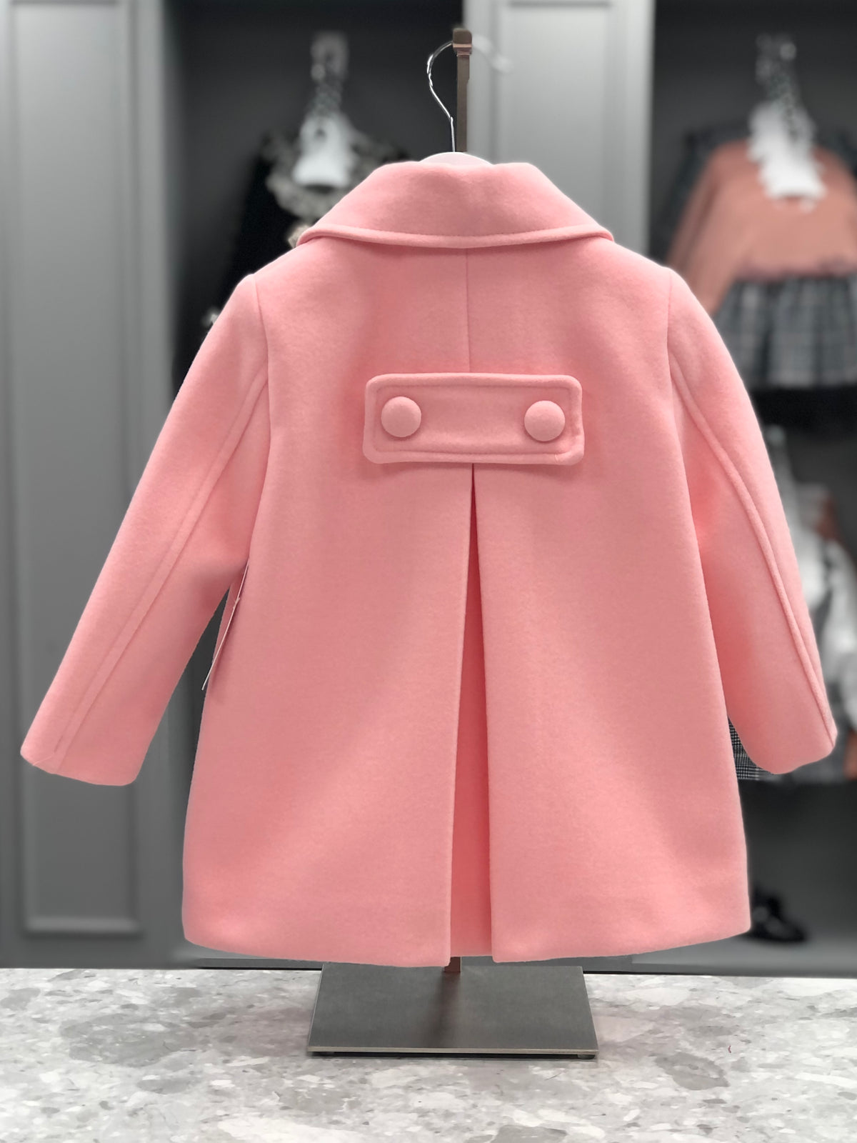 Eva Class Valeria girls pink traditional coat rear view showing buttoned back tab and central pleat
