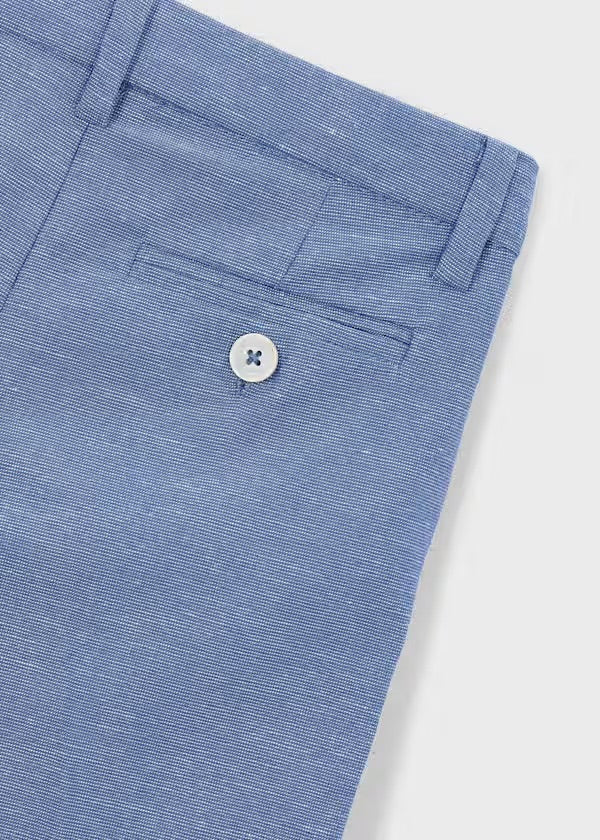 Close-up of the Mayoral Capri-blue trouser waistband, button and pocket