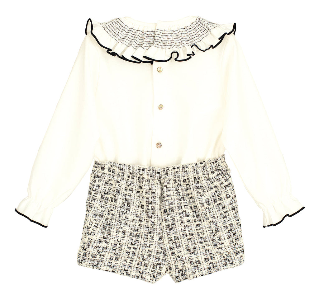 Front view of the Calamaro Alisio ruffle blouse and black and white tweed skort