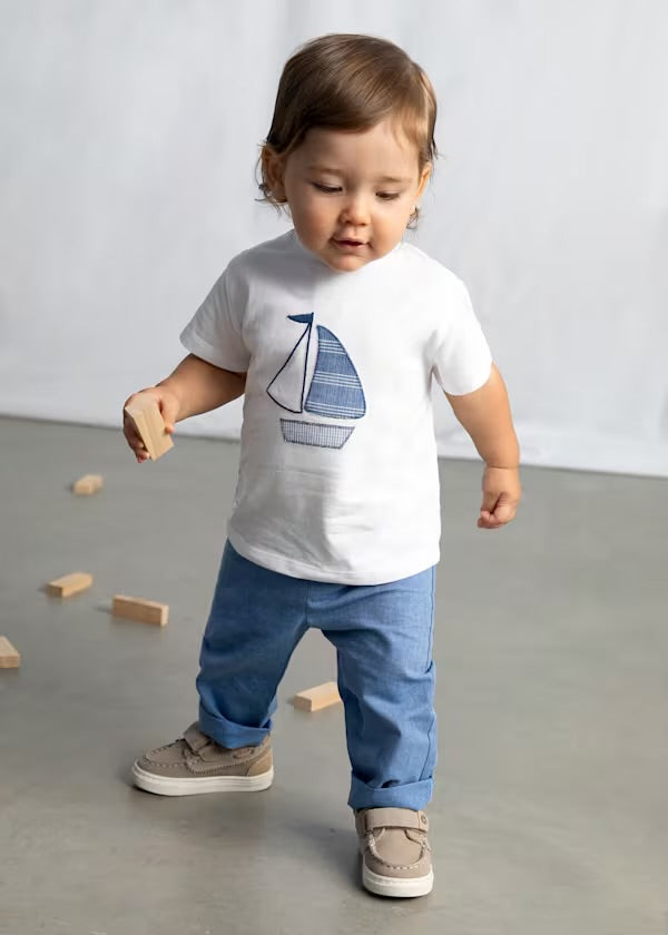Toddler boy wearing the Mayoral sailboat T-shirt and Capri-blue cropped trousers