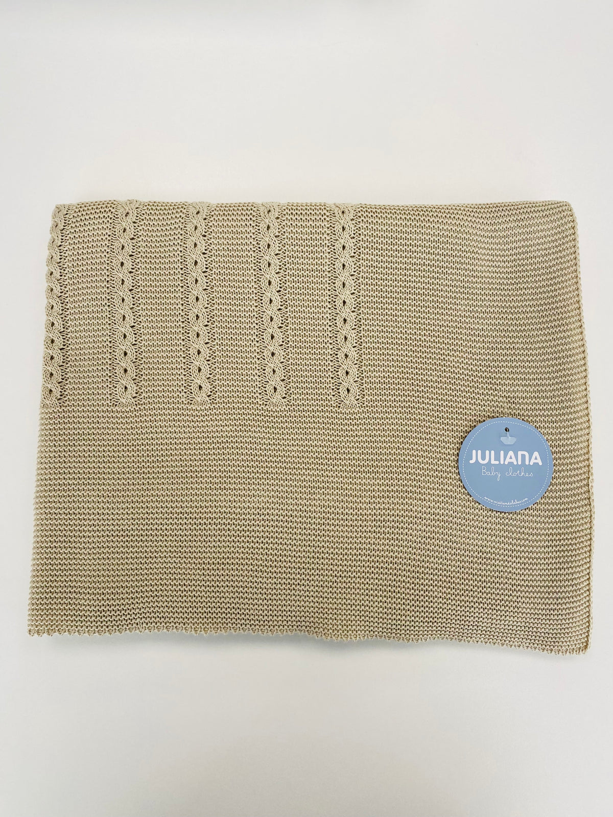Juliana Canela boys beige knitted baby blanket showing its traditional neutral design.