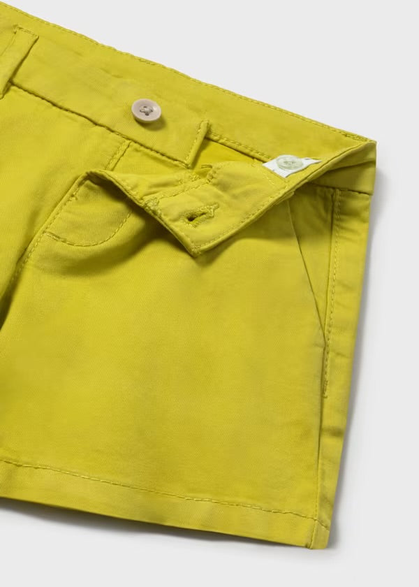 Close-up of the Mayoral shirt sailboat print and Capri-yellow shorts details