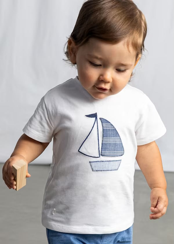 Close-up of a toddler wearing the Mayoral ivory sailboat T-shirt