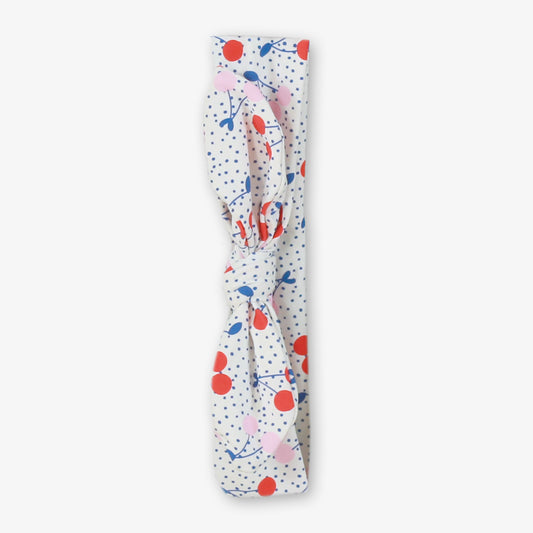Miranda Mon Petit Cherry Girls Headband featuring a white fabric with a colourful cherry print and blue polka dots.