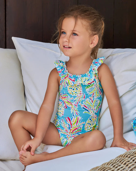 Little girl wearing Tutto Piccolo Hawaii Girls Aquamarine Tropical Print Swimsuit