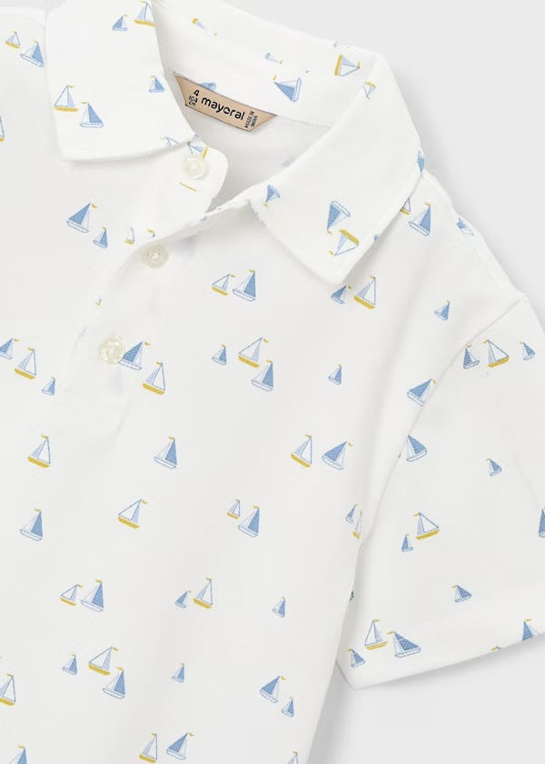 Close-up of the Mayoral polo collar, buttons and blue-and-yellow sailboat print