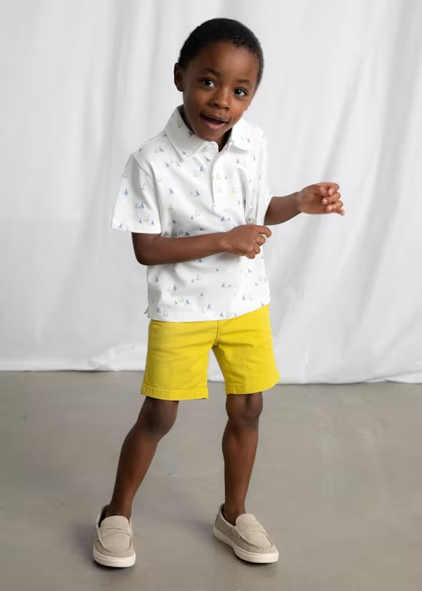 Close-up of the Mayoral Capri-yellow shorts waistband, button and pocket