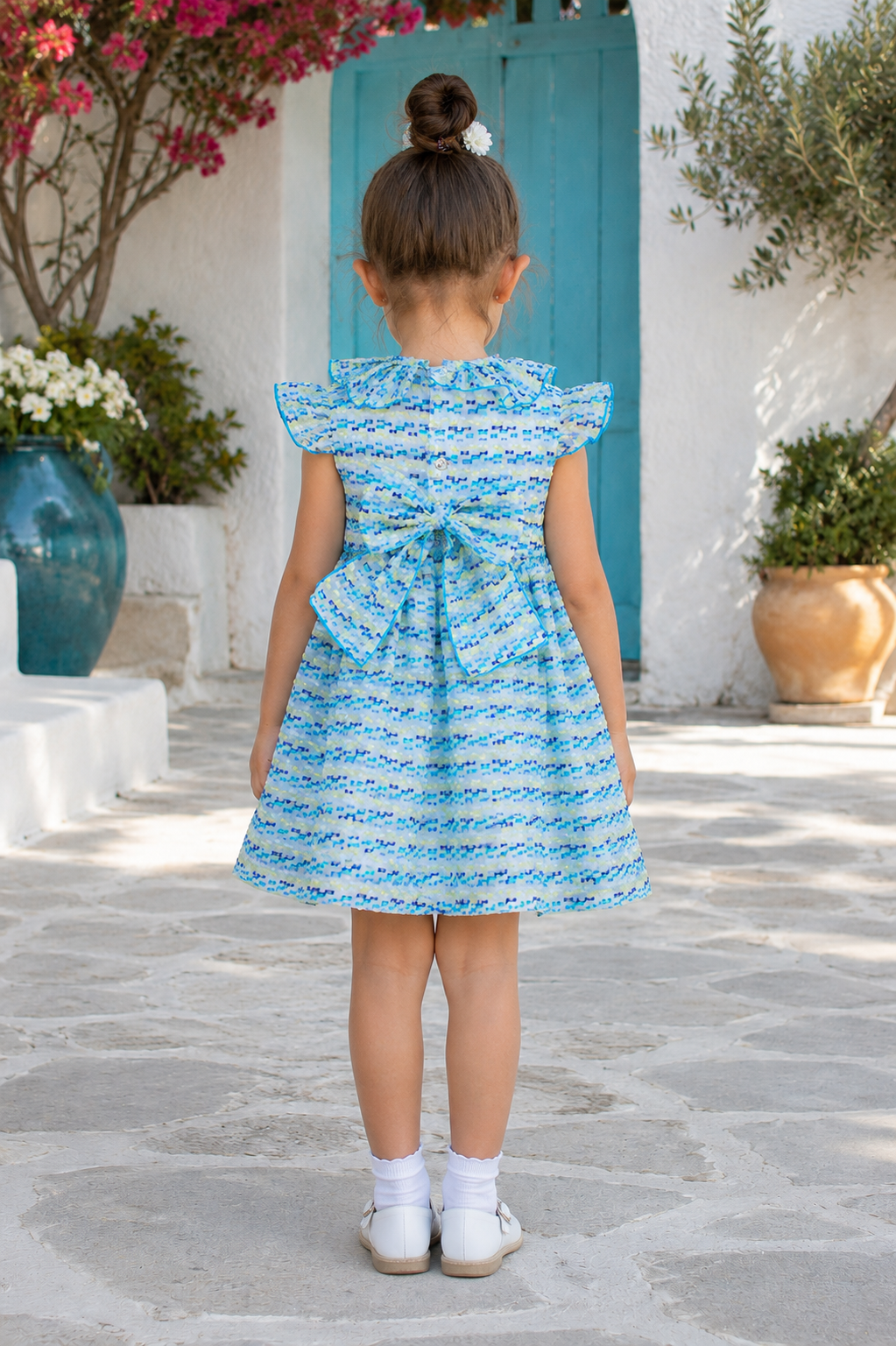 back view of Naxos Marisol Girls Blue & Yellow Hand Smocked Dress