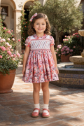 Naxos Amora girls pink floral hand smocked dress with rosebud embroidery and Peter Pan collar.