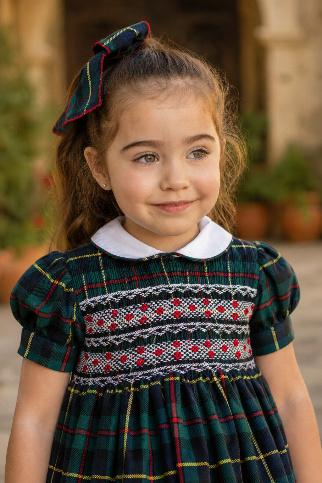 Naxos Escocia girls tartan dress showing intricate red, white and navy hand-smocked bodice detailing.