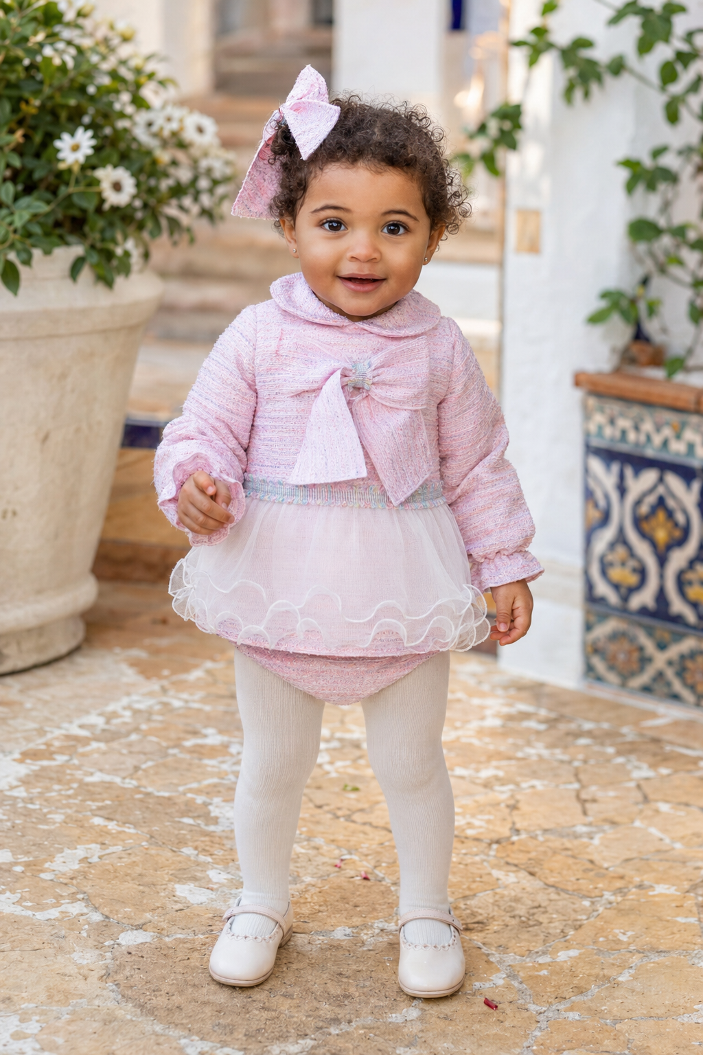 Toddler girl wearing the Naxos pink tweed dress and matching knickers, front view