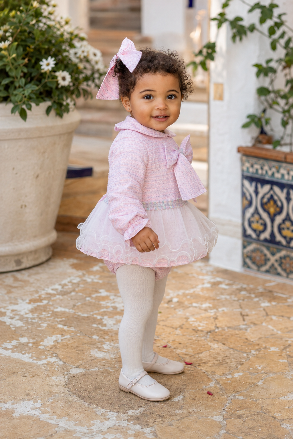 Naxos pink tweed girls dress and knickers shown in a three-quarter lifestyle view
