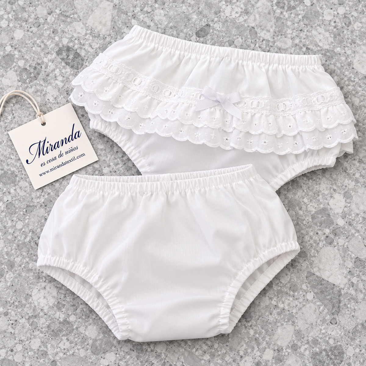 Miranda white cotton broderie anglaise baby knickers 75B showing plain front and frilled back on grey terrazzo