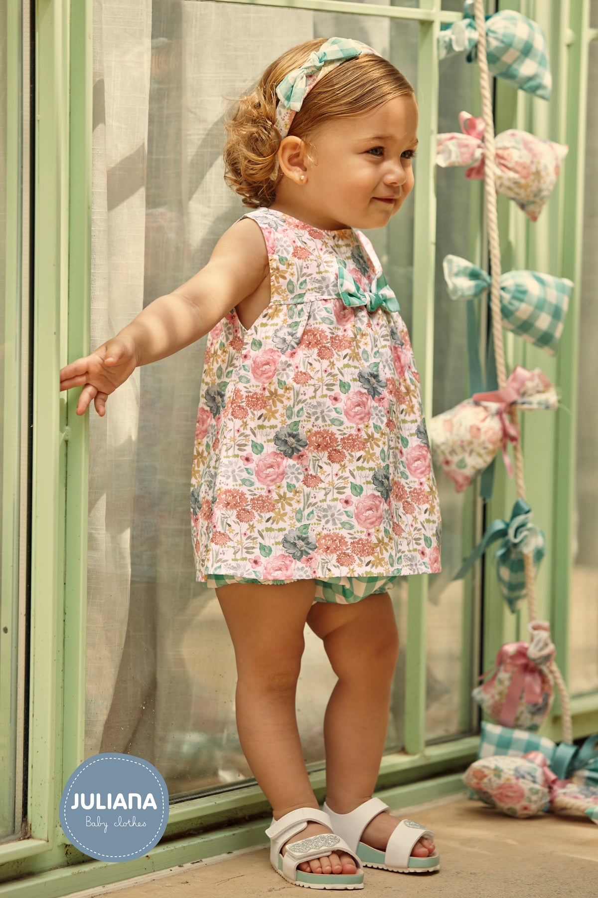 Baby girl wearing the Juliana Azucar floral dress and green gingham knickers - 26092