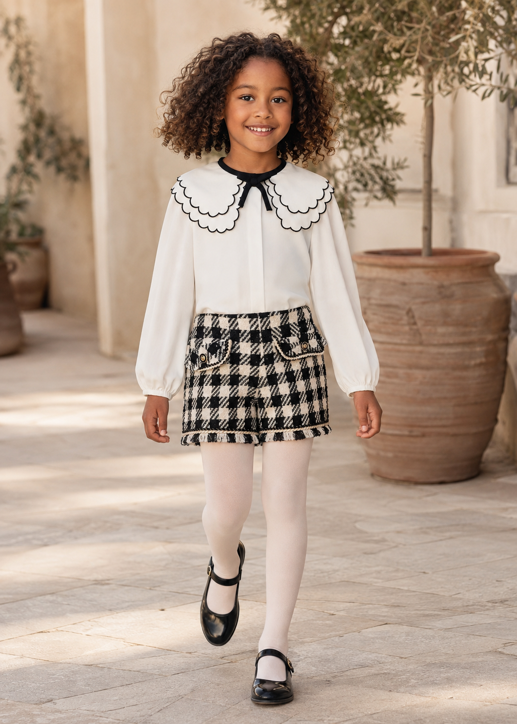 Girl in Spain wearing the Abel & Lula black dogtooth short set - 5612/5716