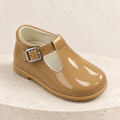 Andanines camel patent leather boys T-bar shoes with rubber sole on a warm ivory background