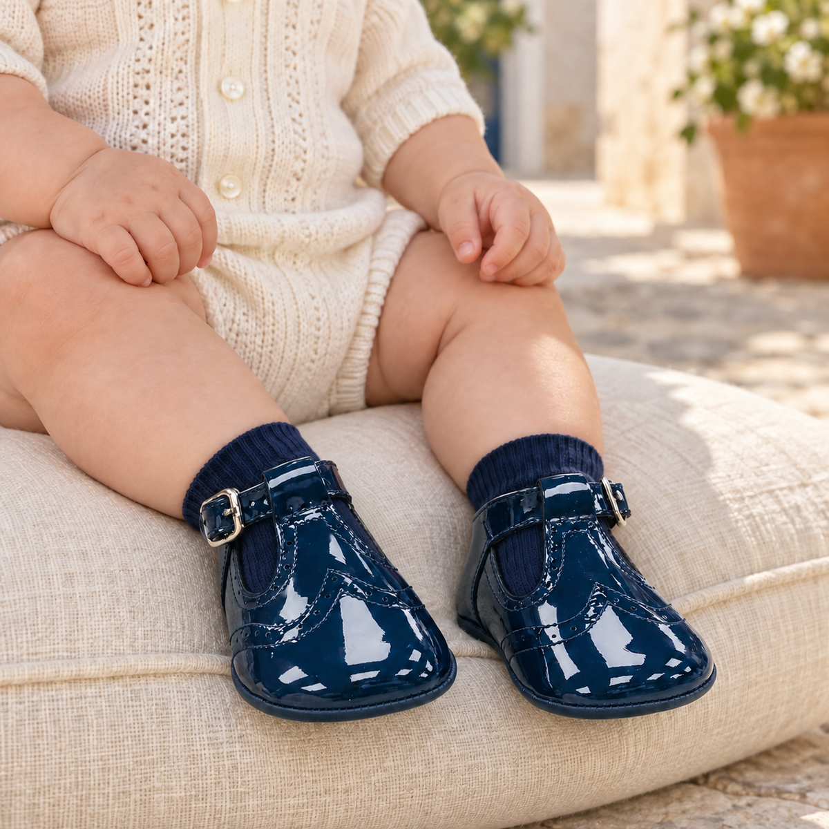 Andanines navy patent leather baby boys T-bar pram shoes worn with navy socks