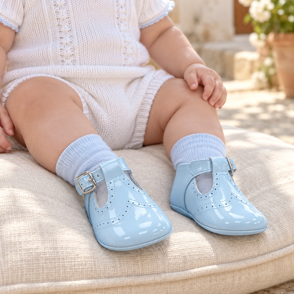 Andanines pale blue patent leather baby boys T-bar pram shoes worn with coordinating socks