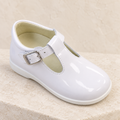 Andanines white patent leather boys T-bar shoes with rubber sole on a warm ivory background