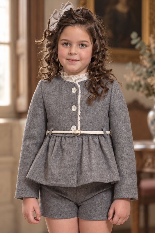 Girl wearing the Babine Versailles grey peplum jacket with cream belt