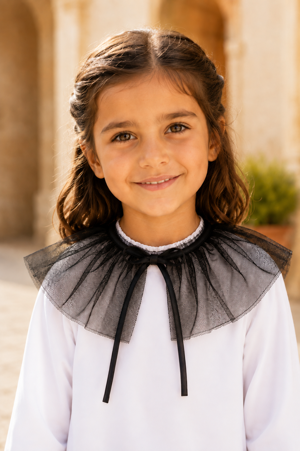 Girl wearing the Calamaro Alisio black tulle frill collar over the white Alisio blouse