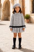 Front view of girl wearing the Calamaro Alisio black and white tweed drop-waist dress