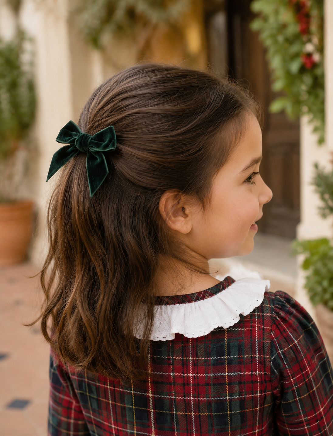 Calamaro Galerna bottle green velvet hair bow worn with the matching tartan dress