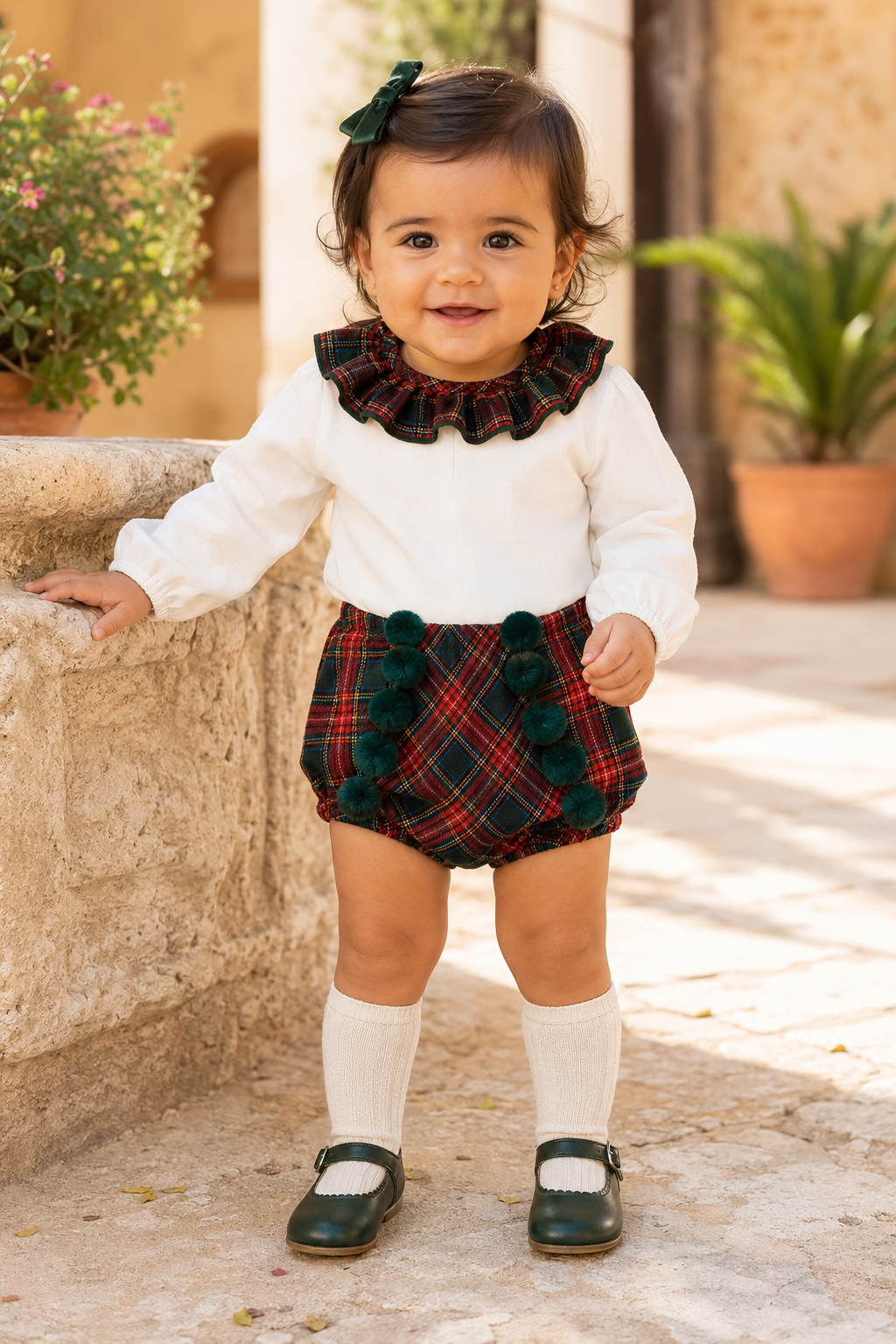 Baby girl wearing the Calamaro Galerna red and green tartan jam-pant set, front view