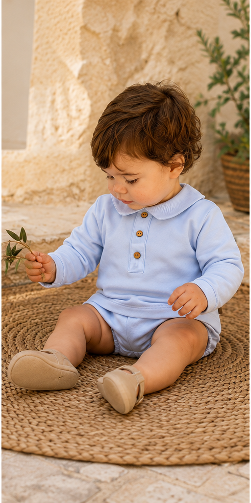 Calamaro Lebeche boys pale blue jam pant set worn by seated toddler in Mediterranean setting