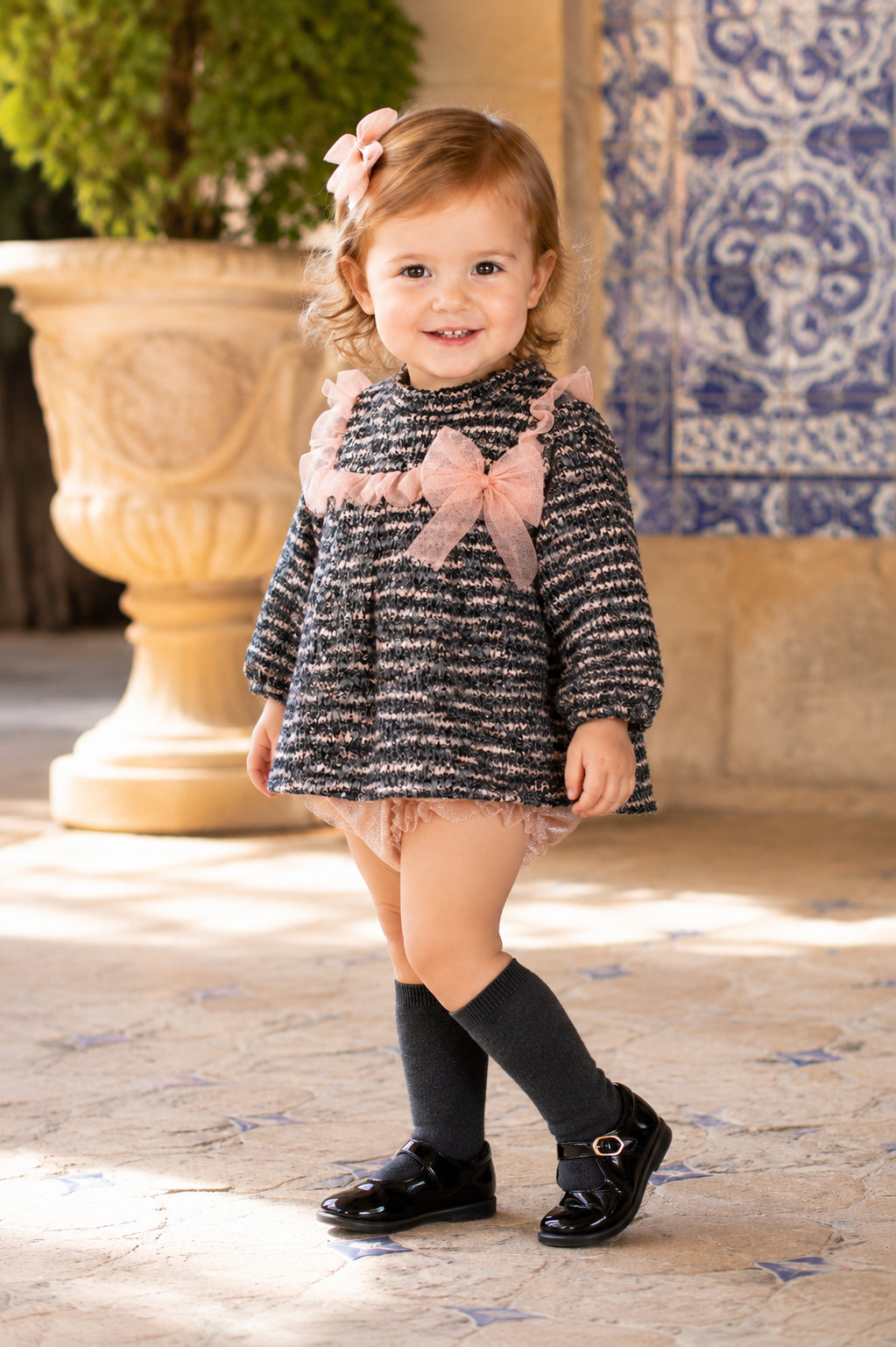 Toddler wearing the Calamaro Lips tweed dress with matching shimmer knickers