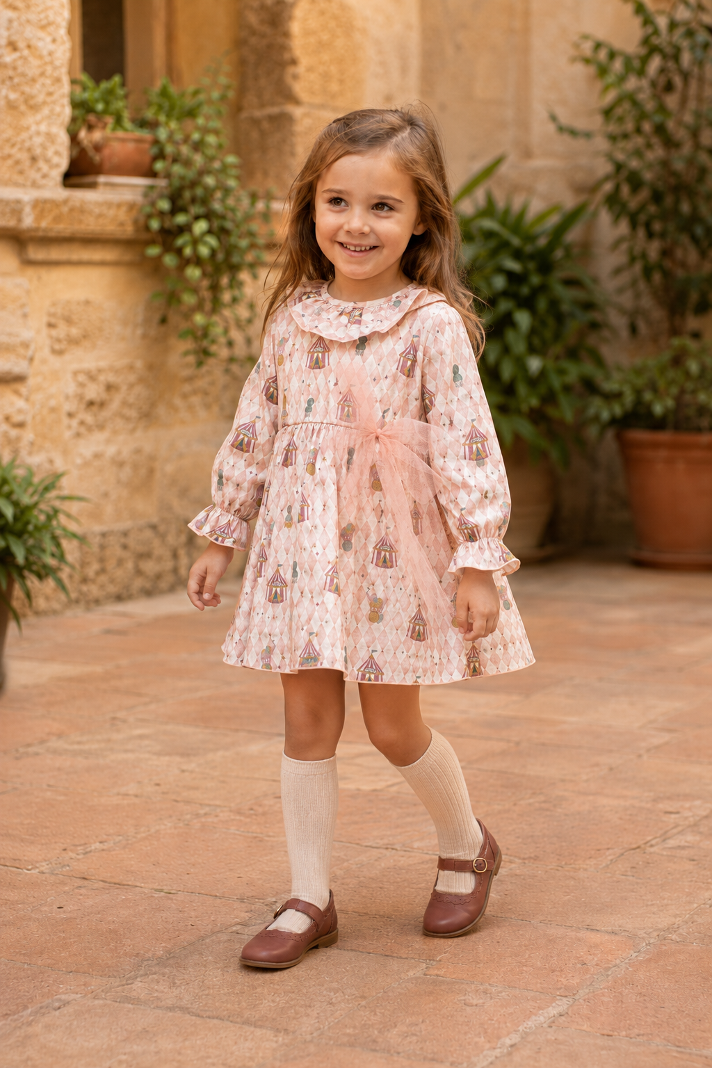 Calamaro Mistral pink circus-print dress with tulle bow, three-quarter view