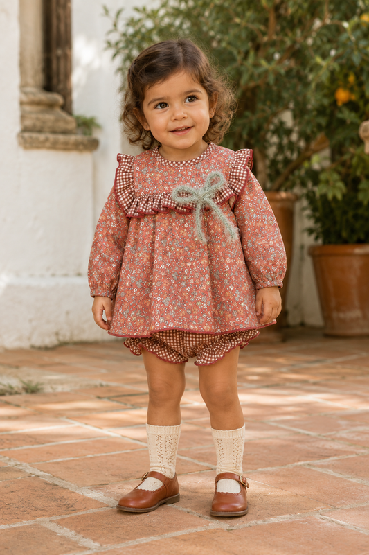 Calamaro Siroco terracotta floral dress and gingham knickers on a toddler, front view