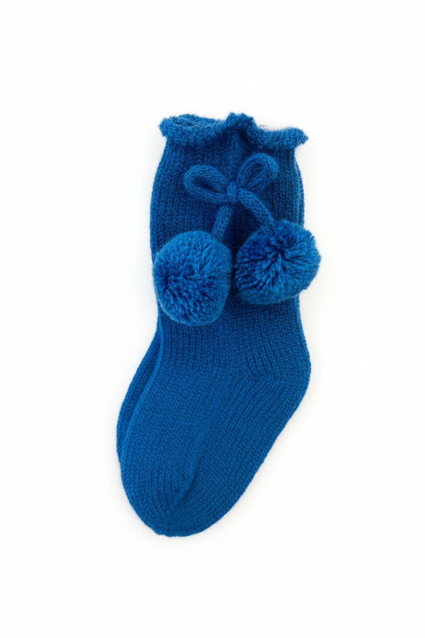 Cobalt blue pom pom sock on white background