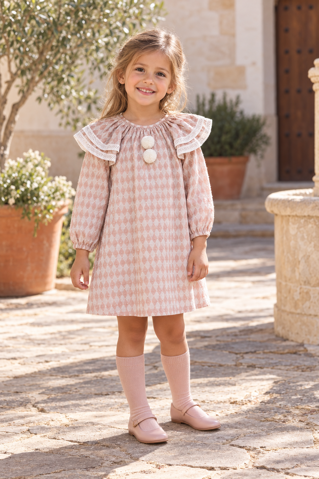 Girl wearing the Foque Circo pink harlequin dress in Spain