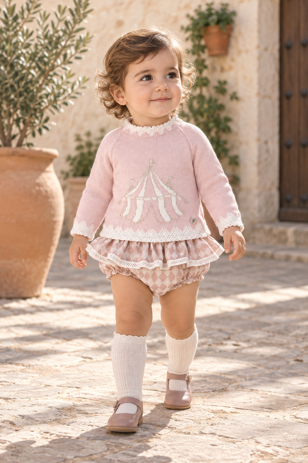 Toddler girl wearing the Foque Circo pink wool and cashmere harlequin jam pant set in Spain