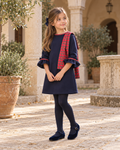 Foque Galletas girls navy tartan A-line dress worn in a Spanish courtyard