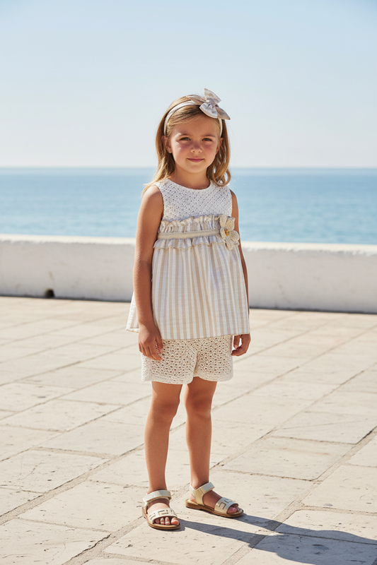Basmarti Rayas girls beige stripe shorts set in a seaside setting