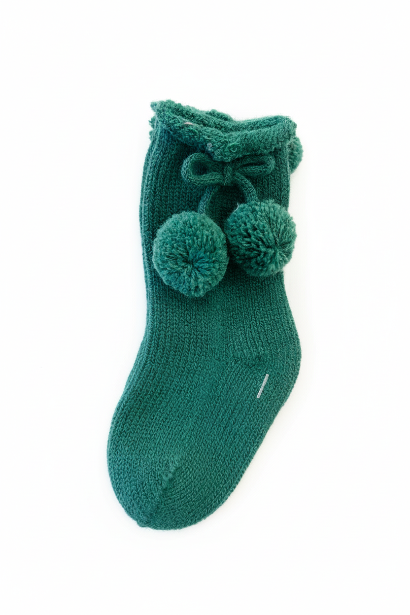 Green pom pom sock on white background