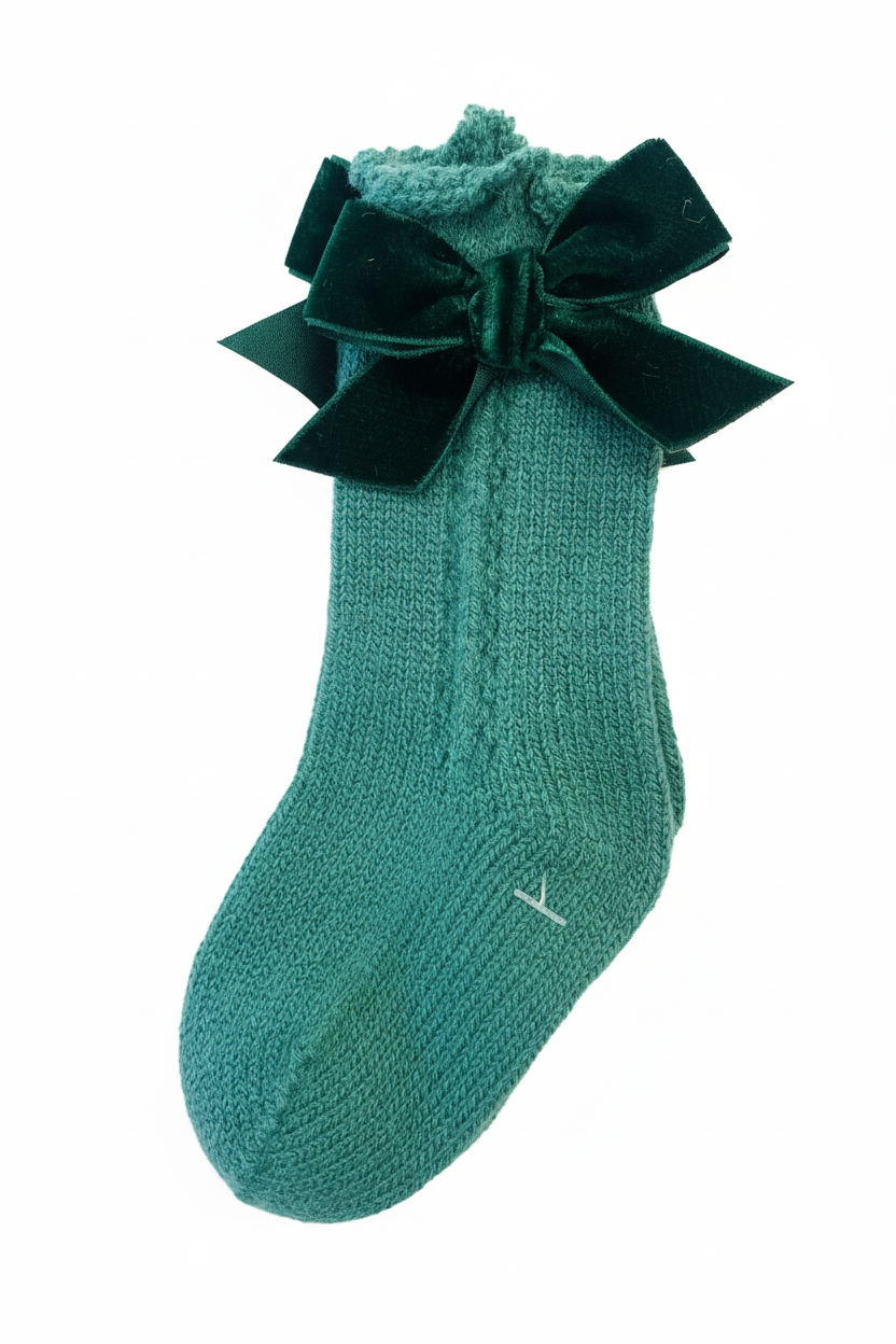 Green velvet bow sock on white background