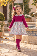 Girl wearing the Juliana Ritmo fuchsia knitted floral dress in a Spanish courtyard