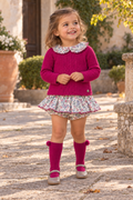 Girl wearing Juliana Ritmo fuchsia knitted floral jam pant set with matching pom pom socks