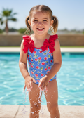 Little girl in cherry print swimsuit by pool